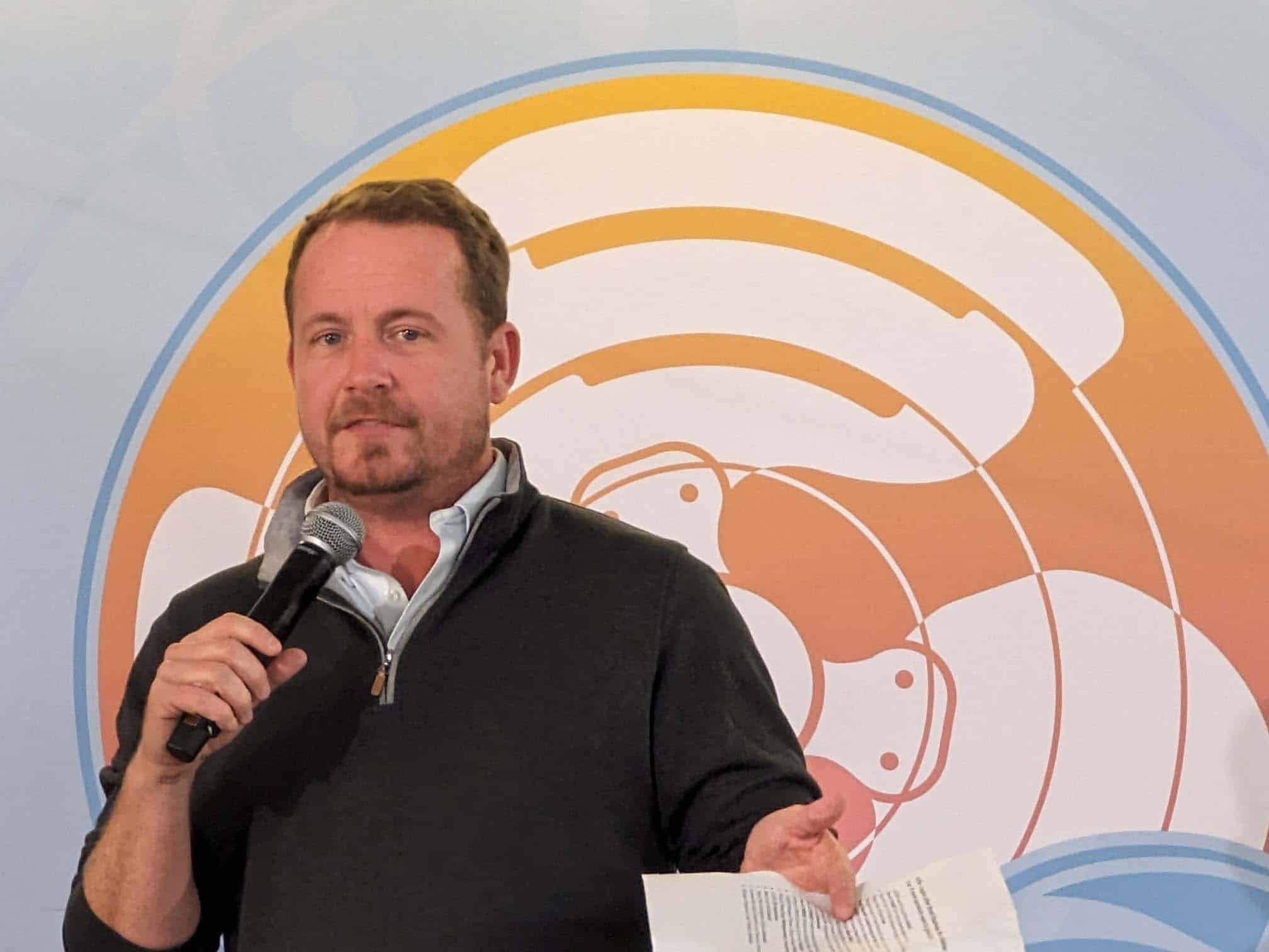 Bryan Orr speaking at an event, representing consulting services